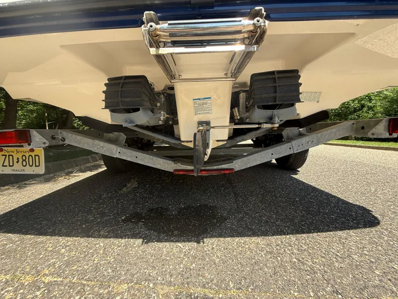 Slide: The Image of 2022 Yamaha AR210 boat on trailer, rear view showing dual engines and ladder. - 33