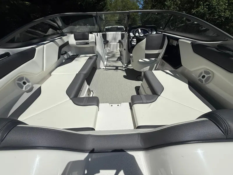 Slide: The Image of 2022 Yamaha Boats AR210 interior with sleek seating and modern dashboard design. - 6