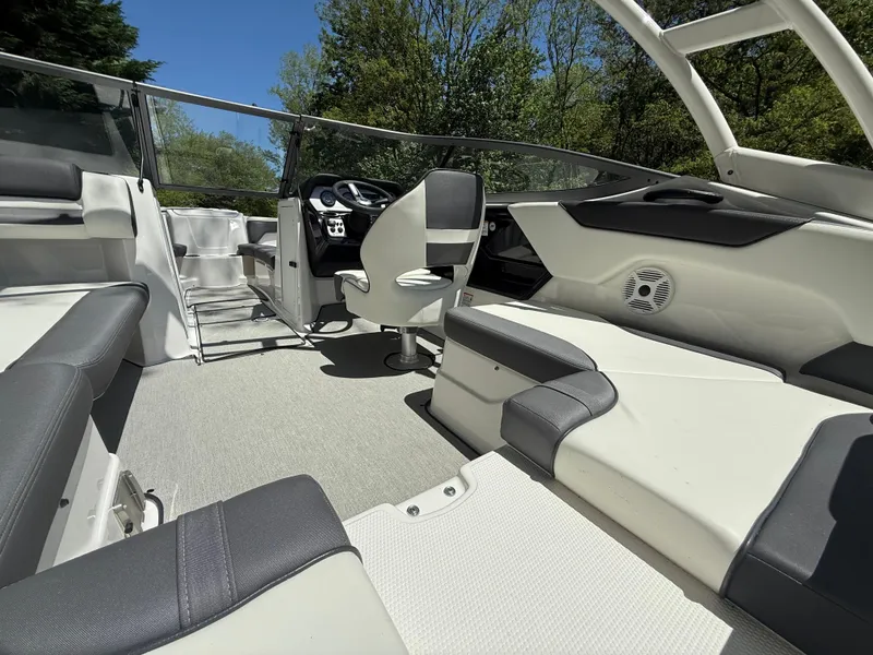 Slide: The Image of 2022 Yamaha AR210 boat interior with sleek seating and modern dashboard. - 8