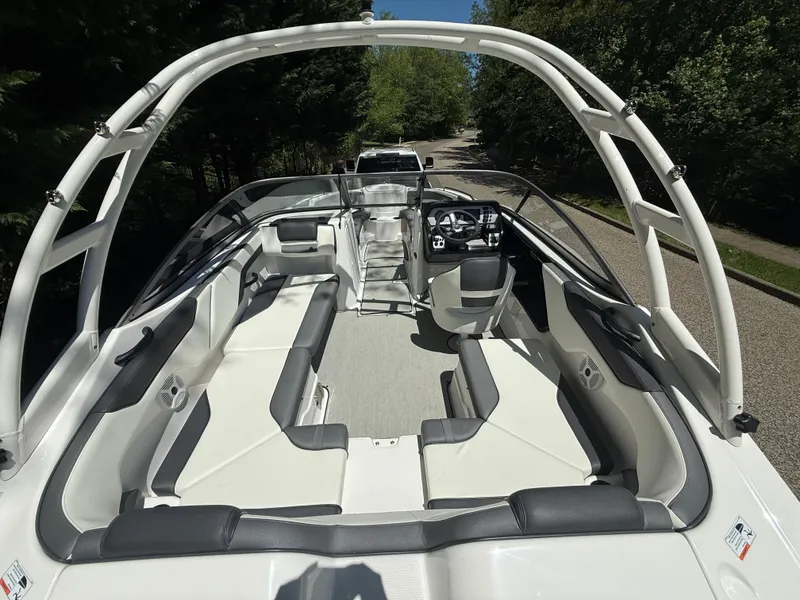 Slide: The Image of 2022 Yamaha AR210 boat interior with sleek seating and modern dashboard. - 9