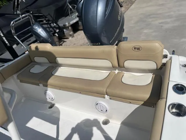 Slide: The Image of 2020 Key West 219 FS boat interior with beige seating and motor. - 10