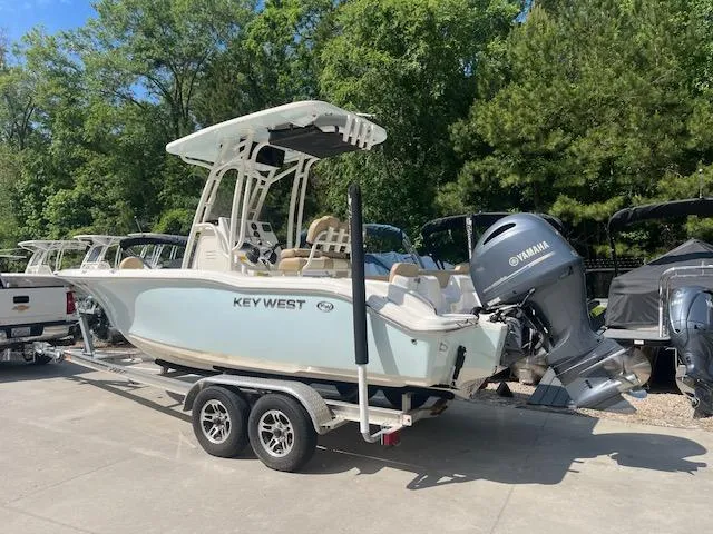 Slide: The Image of 2020 Key West 219 FS boat on trailer with Yamaha outboard, parked outdoors. - 2