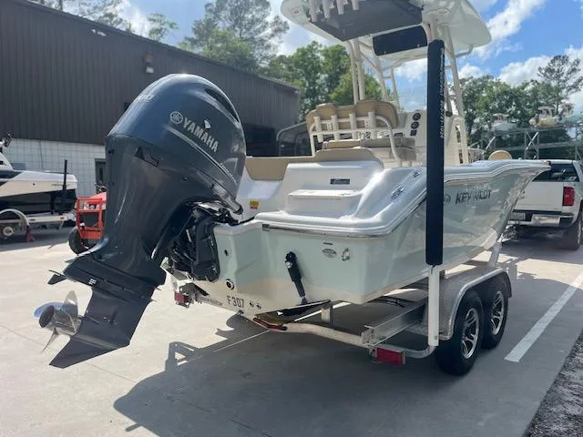 Slide: The Image of 2020 Key West 219 FS boat on trailer with Yamaha outboard motor in a parking area. - 4