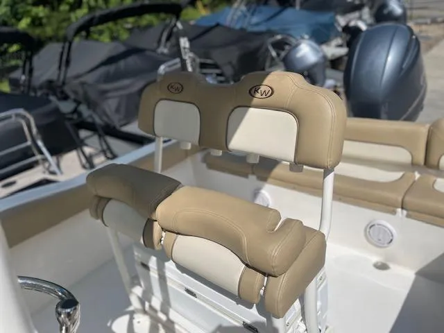 Slide: The Image of 2020 Key West 219 FS boat interior with tan and white cushioned seating. - 9