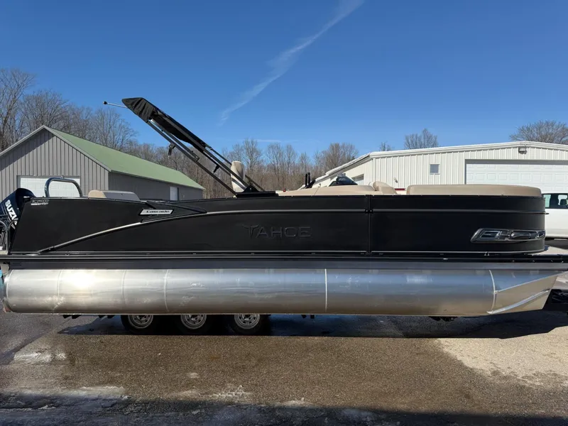 Slide: The Image of 2025 Tahoe Pontoon Cascade Versatile Rear Lounger, black exterior, parked outdoors on a sunny day. - 20