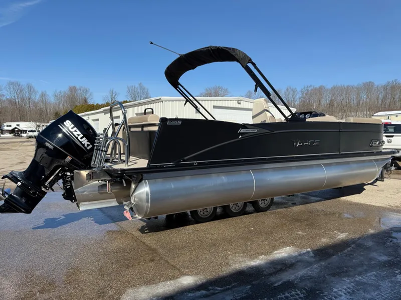 Slide: The Image of 2025 Tahoe Pontoon Cascade Versatile Rear Lounger with Suzuki engine, parked outdoors. - 21