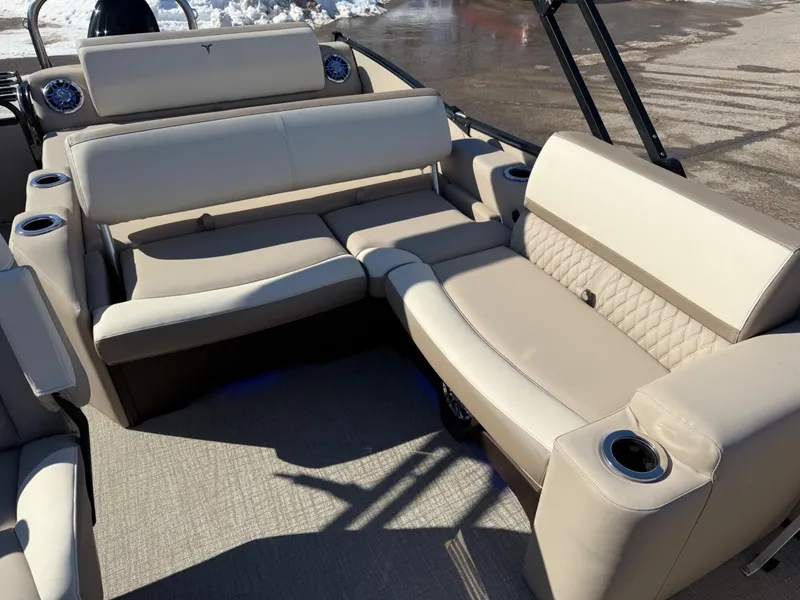 Slide: The Image of 2025 Tahoe Pontoon Cascade Versatile Rear Lounger with beige seating and cup holders. - 3