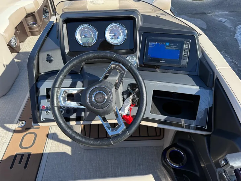 Slide: The Image of 2025 Tahoe Pontoon Cascade Versatile Rear Lounger dashboard with steering wheel and digital display. - 8