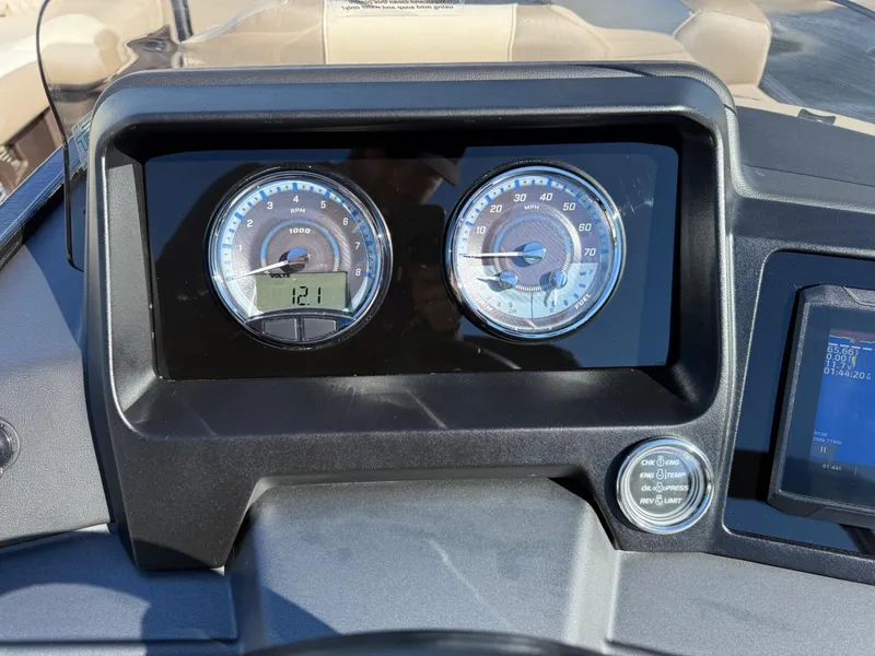 Slide: The Image of Dashboard of 2025 Tahoe Pontoon Cascade Versatile Rear Lounger with gauges and digital display. - 9