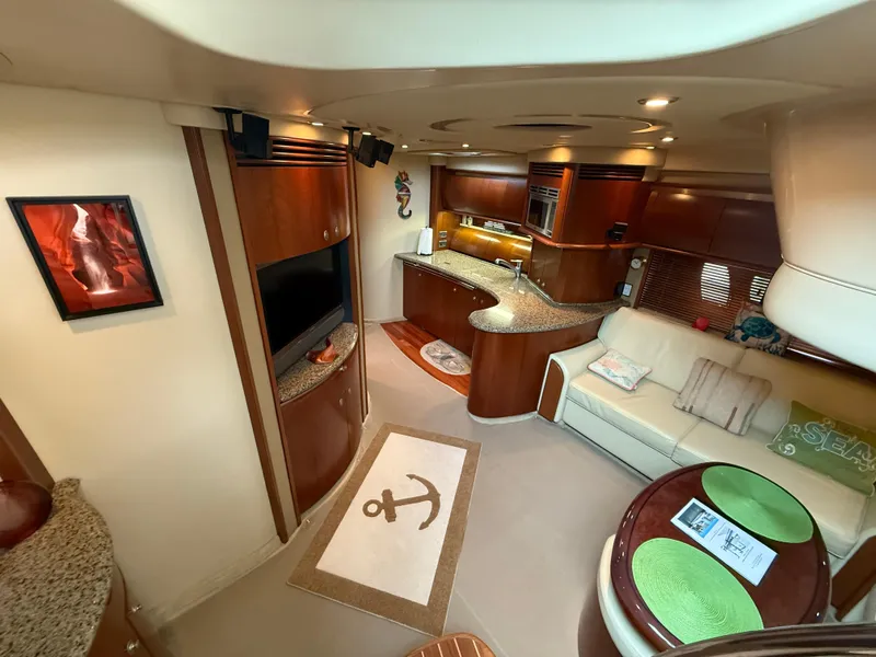 Slide: The Image of Luxurious interior of 2006 Sea Ray 52 Sundancer yacht with modern kitchen and cozy seating area. - 10