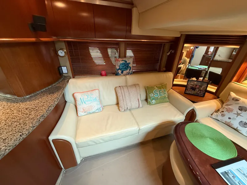 Slide: The Image of Interior of 2006 Sea Ray 52 Sundancer yacht with cozy seating and decorative pillows. - 14