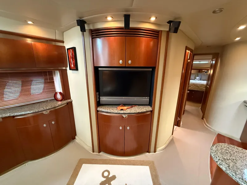 Slide: The Image of Luxurious interior of 2006 Sea Ray 52 Sundancer yacht with wood cabinetry and TV. - 15