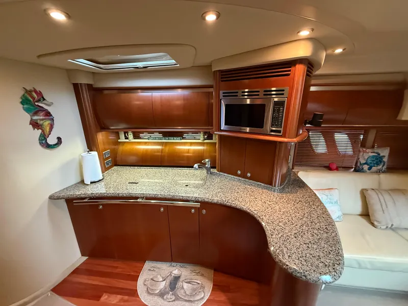 Slide: The Image of Luxurious 2006 Sea Ray 52 Sundancer yacht interior with modern kitchen and elegant wood finishes. - 16