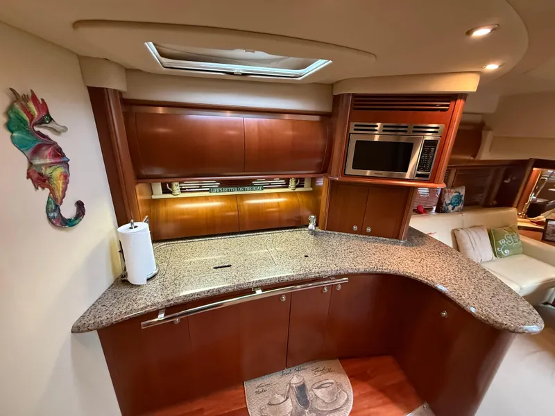 Slide: The Image of Luxurious kitchen interior of 2006 Sea Ray 52 Sundancer yacht with modern amenities. - 17