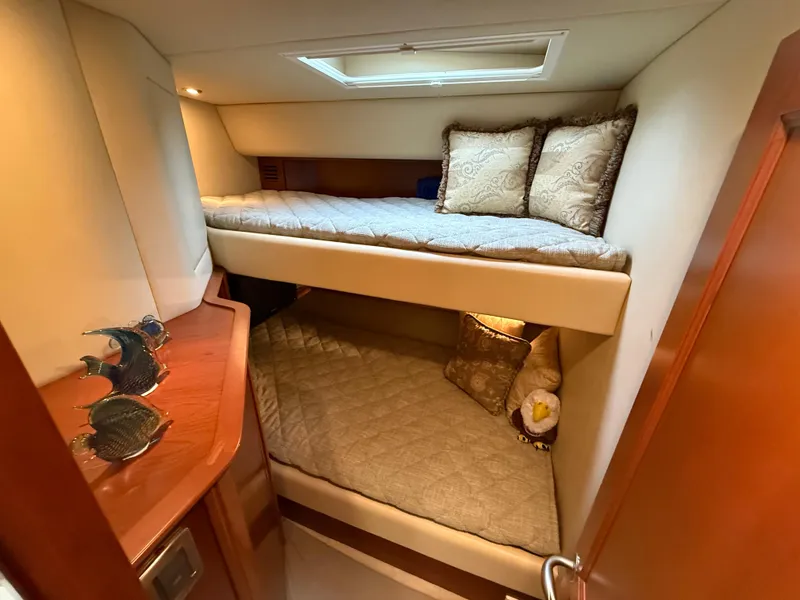 Slide: The Image of Interior cabin of 2006 Sea Ray 52 Sundancer with bunk beds and decorative pillows. - 18
