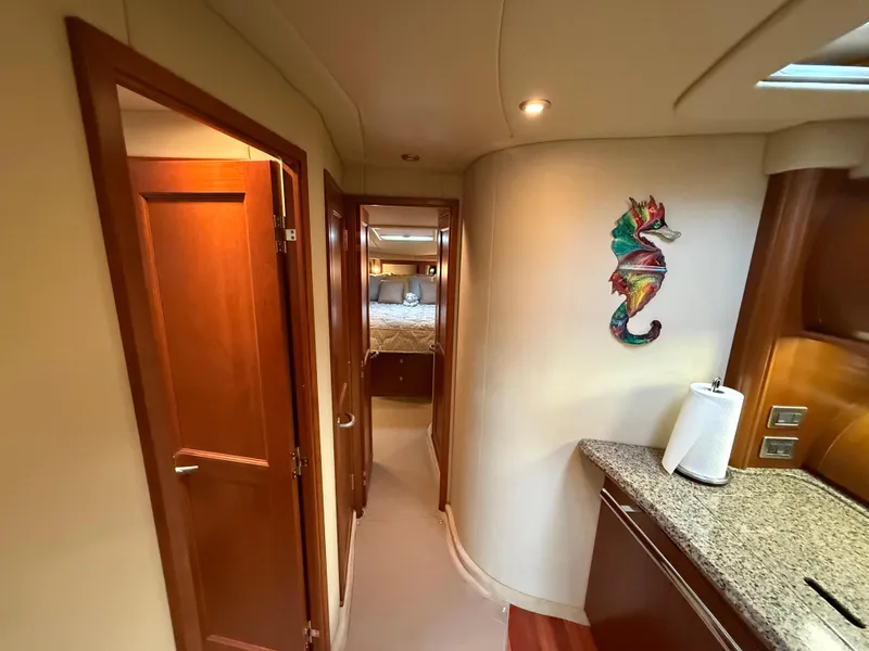 Slide: The Image of Interior of 2006 Sea Ray 52 Sundancer yacht with seahorse decor and wooden cabinetry. - 19