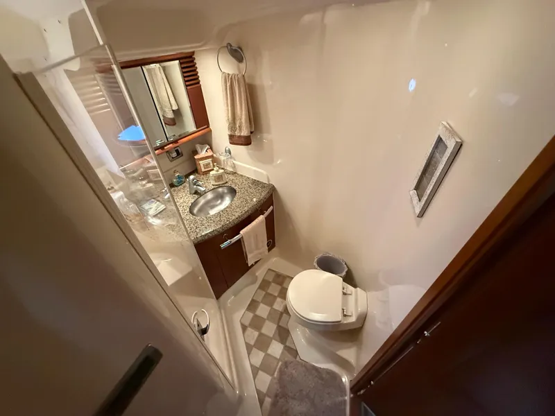 Slide: The Image of Bathroom interior of 2006 Sea Ray 52 Sundancer yacht, featuring sink and toilet. - 23