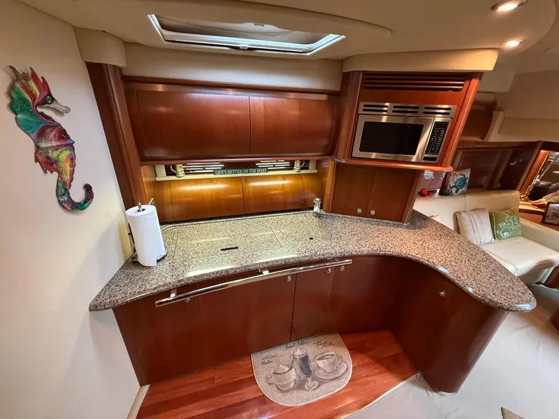 Slide: The Image of Luxurious 2006 Sea Ray 52 Sundancer yacht kitchen with granite countertops and modern appliances. - 31