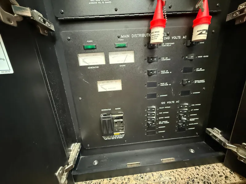 Slide: The Image of Electrical panel of a 2006 Sea Ray 52 Sundancer boat with switches and meters. - 36