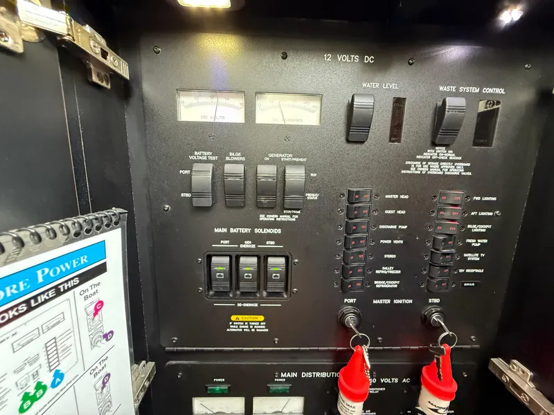 Slide: The Image of Electrical control panel of a 2006 Sea Ray 52 Sundancer yacht, featuring switches and gauges. - 37