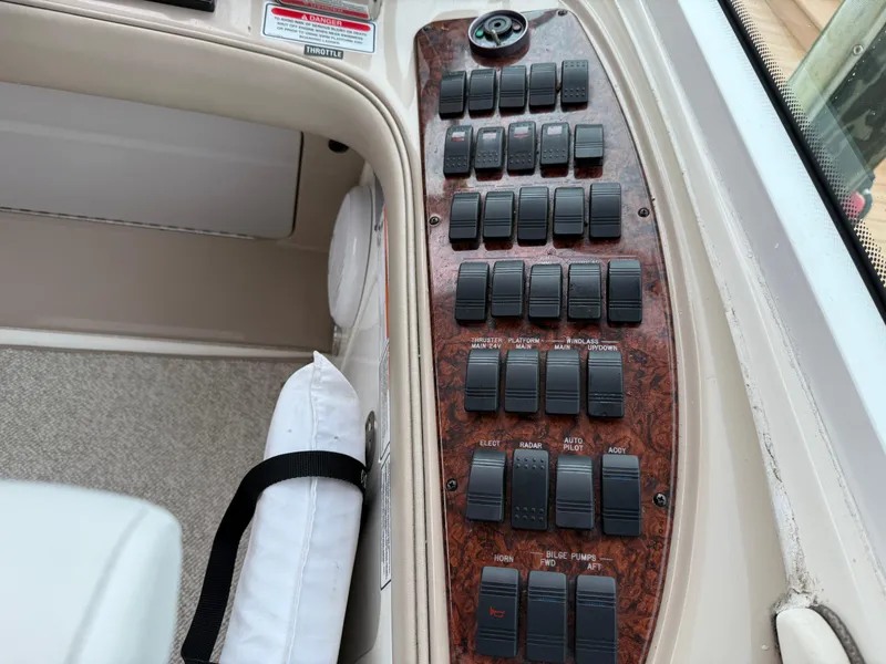 Slide: The Image of Control panel of a 2006 Sea Ray 52 Sundancer yacht with multiple switches. - 38