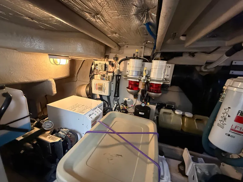 Slide: The Image of Engine room of 2006 Sea Ray 52 Sundancer with equipment and storage containers. - 39