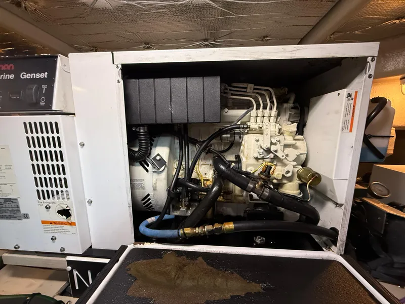 Slide: The Image of Engine compartment of a 2006 Sea Ray 52 Sundancer, showcasing mechanical components and wiring. - 42