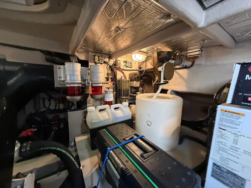 Slide: The Image of Engine room of 2006 Sea Ray 52 Sundancer with equipment and storage containers. - 43