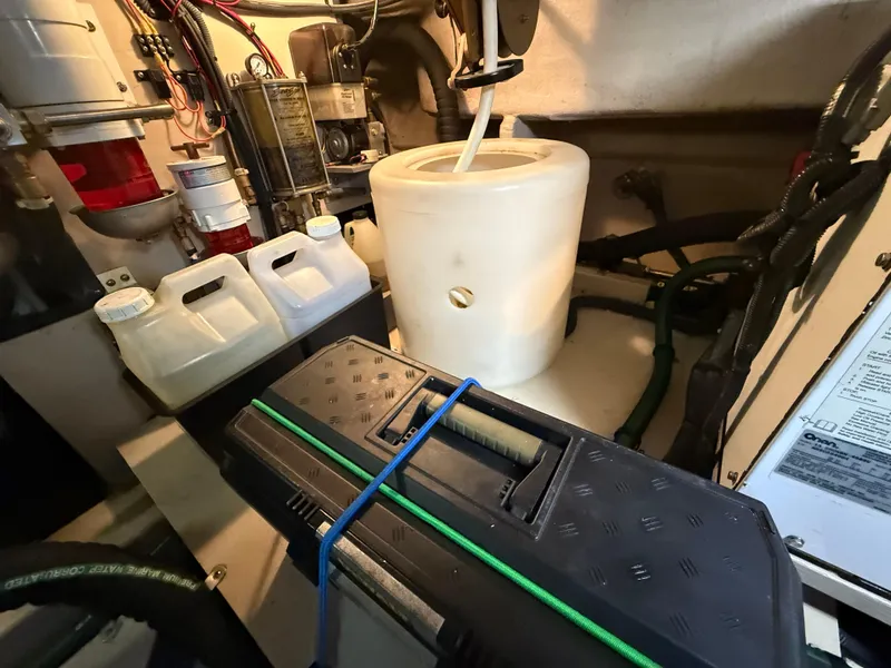 Slide: The Image of Engine room of 2006 Sea Ray 52 Sundancer with maintenance equipment and storage containers. - 46