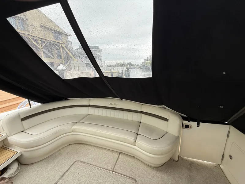 Slide: The Image of 2006 Sea Ray 52 Sundancer interior with curved seating and covered windows. - 5