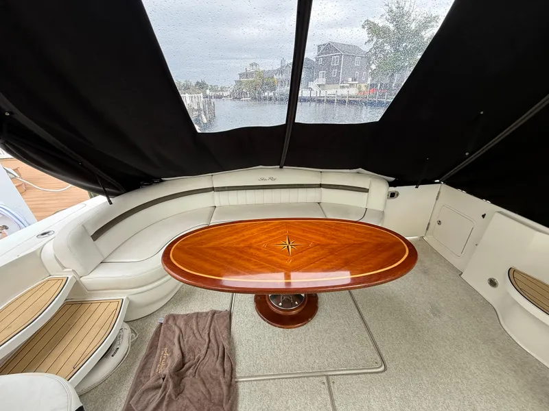 Slide: The Image of Interior of 2006 Sea Ray 52 Sundancer with elegant wood table and curved seating. - 6