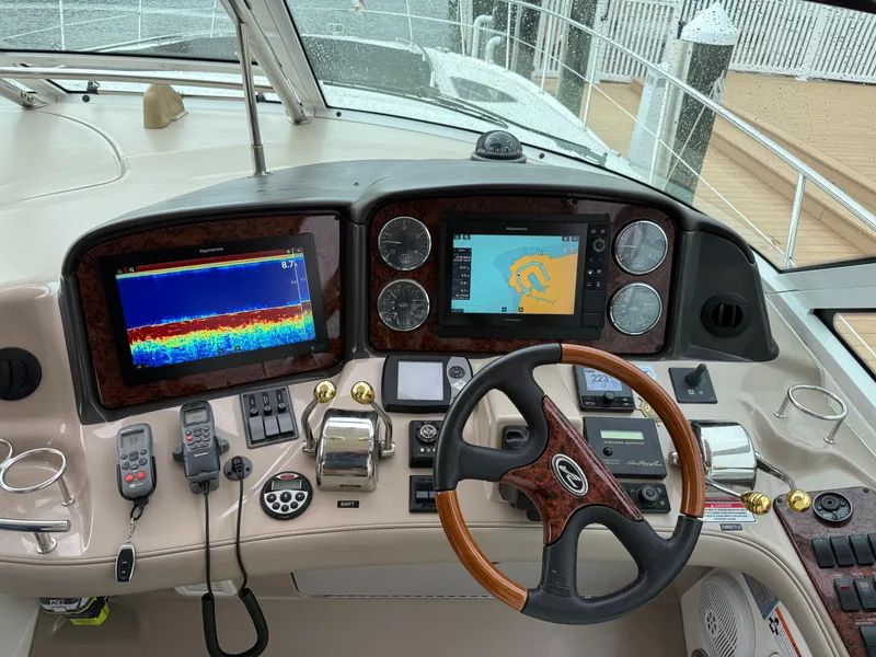 Slide: The Image of 2006 Sea Ray 52 Sundancer helm with navigation screens and controls. - 7