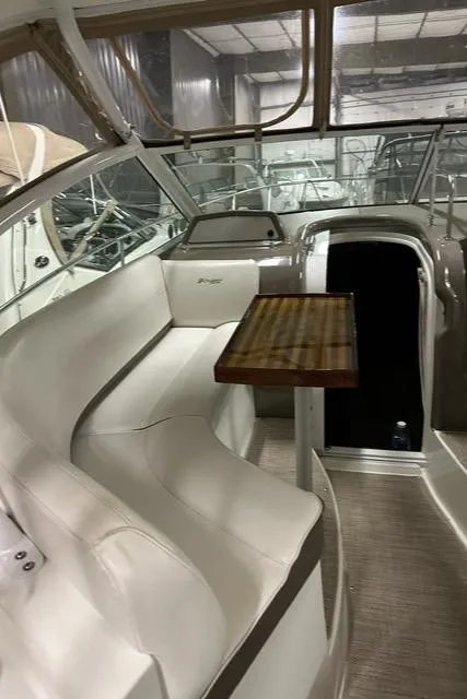 Slide: The Image of 2008 Cruisers Yachts 360 Express interior with white seating and wooden table. - 13