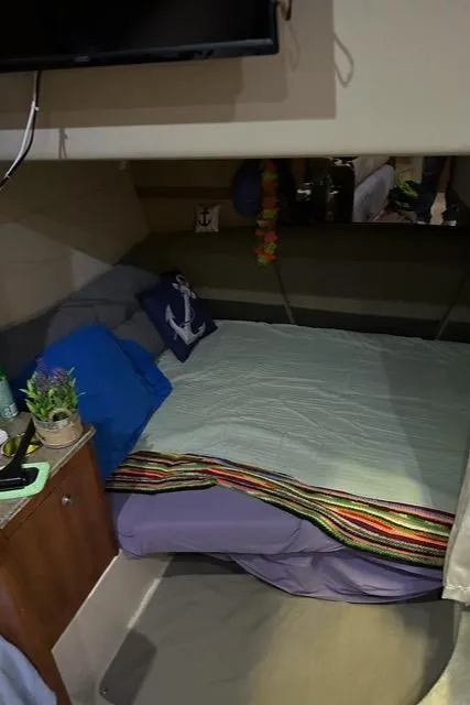 Slide: The Image of 2008 Cruisers Yachts 360 Express cabin with cozy bed and nautical decor. - 18