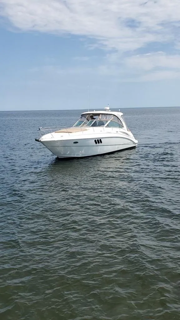 Slide: The Image of 2008 Cruisers Yachts 360 Express on calm water under a partly cloudy sky. - 6