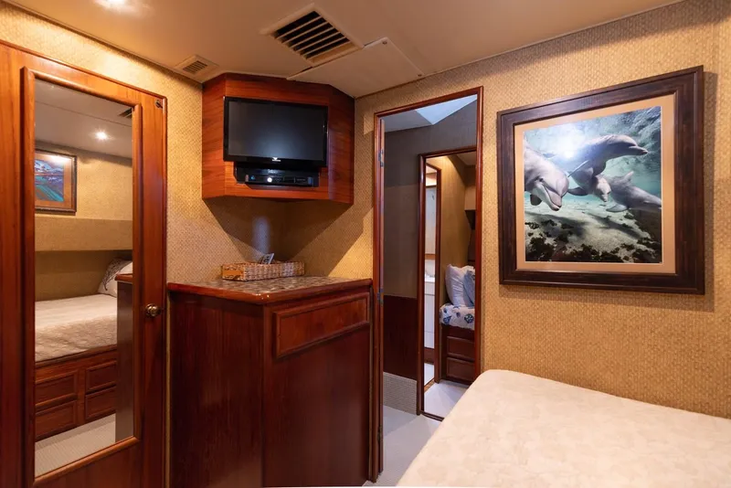 Slide: The Image of Interior of 1987 Ocean Yachts Convertible, featuring wood cabinetry and marine-themed artwork. - 15