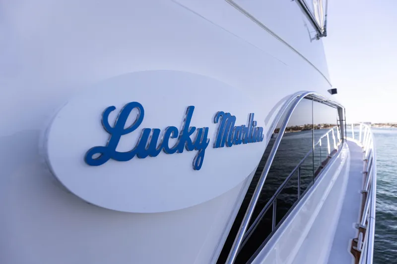 Slide: The Image of 1987 Ocean Yachts Convertible with "Lucky Marlin" nameplate, docked by the water. - 25
