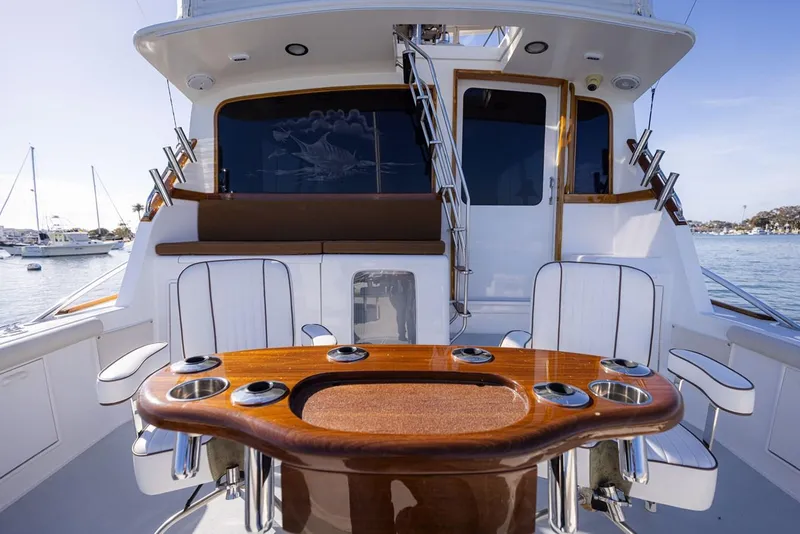 Slide: The Image of 1987 Ocean Yachts Convertible boat deck with seating and polished wood table. - 30