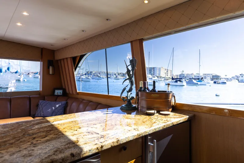 Slide: The Image of Interior of 1987 Ocean Yachts Convertible with marina view through large windows. - 7