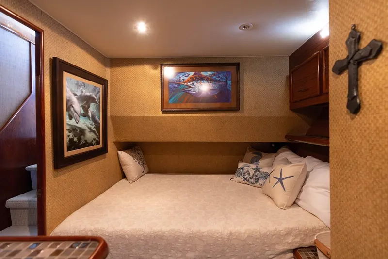 Slide: The Image of Cozy bedroom in 1987 Ocean Yachts Convertible, featuring nautical decor and artwork. - 14