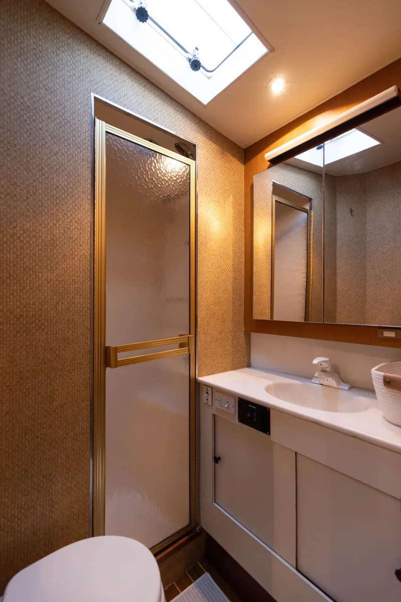 Slide: The Image of 1987 Ocean Yachts Convertible bathroom with shower, sink, and mirror. - 16