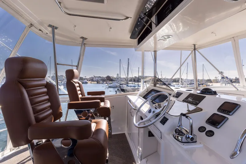Slide: The Image of 1987 Ocean Yachts Convertible cockpit with leather seats and marina view. - 20