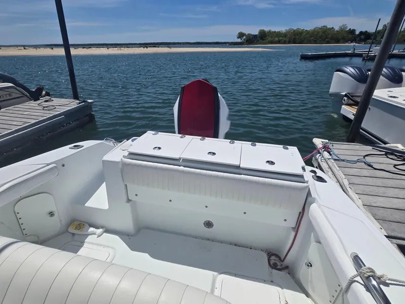 Slide: The Image of 2004 Baja 250 Sportfish boat docked by a serene lake under a clear blue sky. - 6