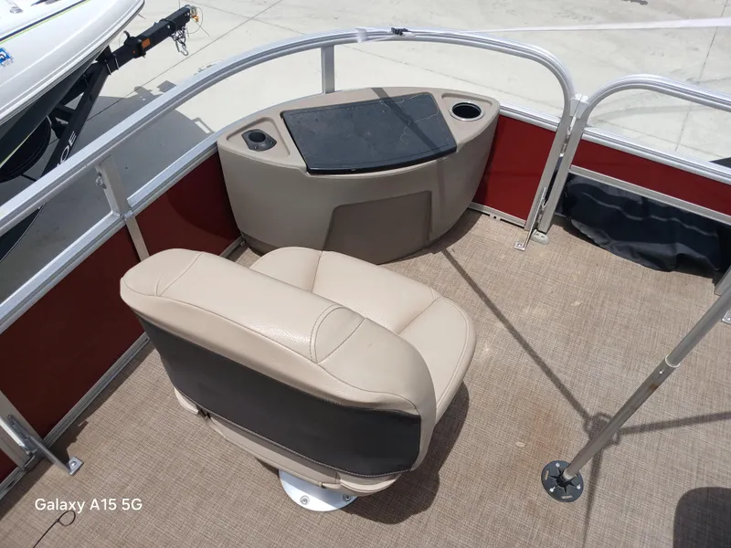 Slide: The Image of 2023 Sun Tracker 18BASSBUGGY boat interior with beige seating and fishing station. - 10