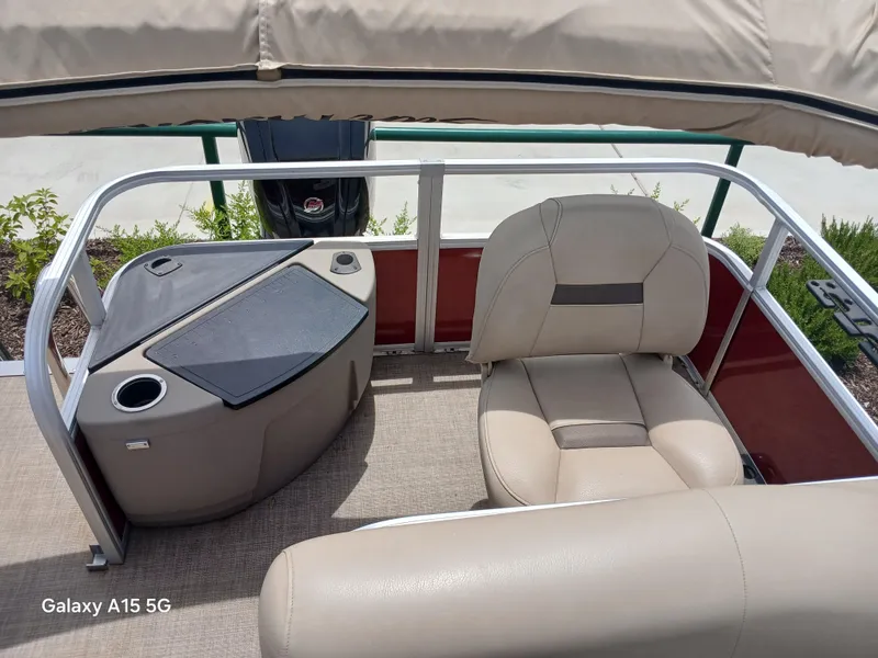 Slide: The Image of 2023 Sun Tracker 18BASSBUGGY boat interior with beige seating and console. - 7