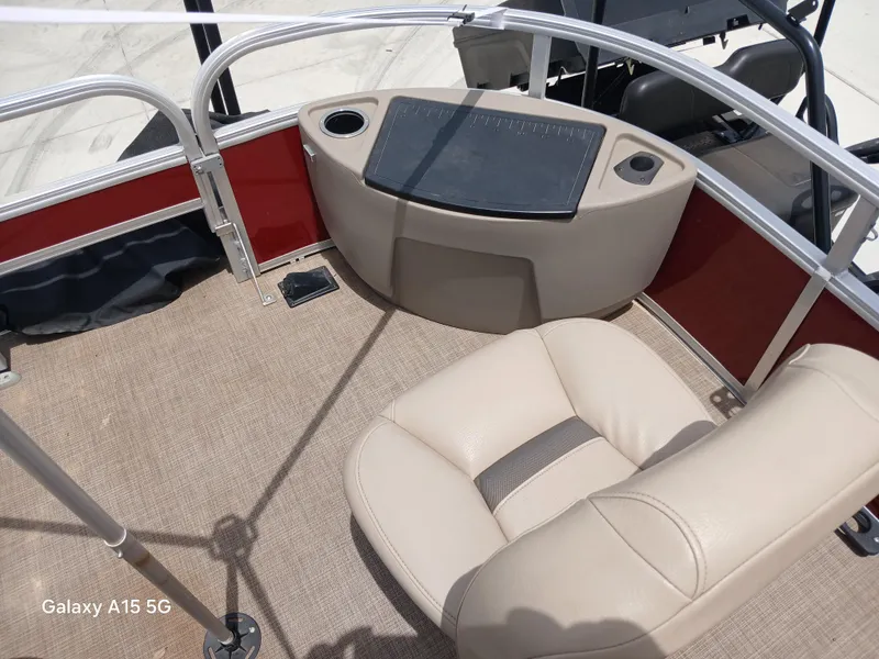 Slide: The Image of 2023 Sun Tracker 18BASSBUGGY boat interior with beige seating and control panel. - 9