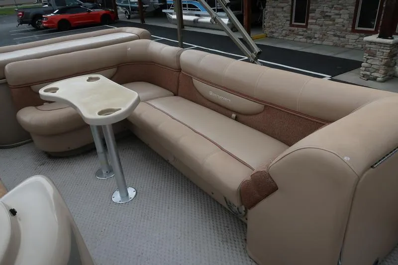 Slide: The Image of 2008 Godfrey SAN PAN 2500 RE pontoon boat interior with beige seating and table. - 17