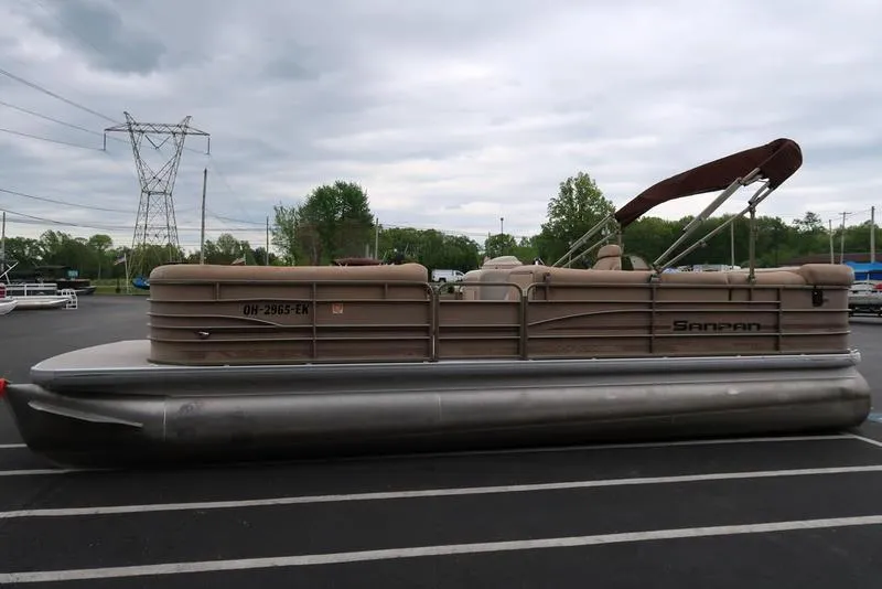 Slide: The Image of 2008 Godfrey SAN PAN 2500 RE pontoon boat parked in a lot under cloudy skies. - 4