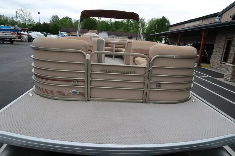 Slide: The Image of 2008 Godfrey SAN PAN 2500 RE pontoon boat, beige seating, docked outdoors. - 6