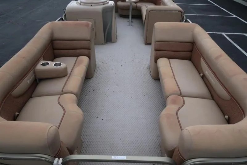Slide: The Image of 2008 Godfrey SAN PAN 2500 RE pontoon boat interior with beige seating and cup holders. - 7